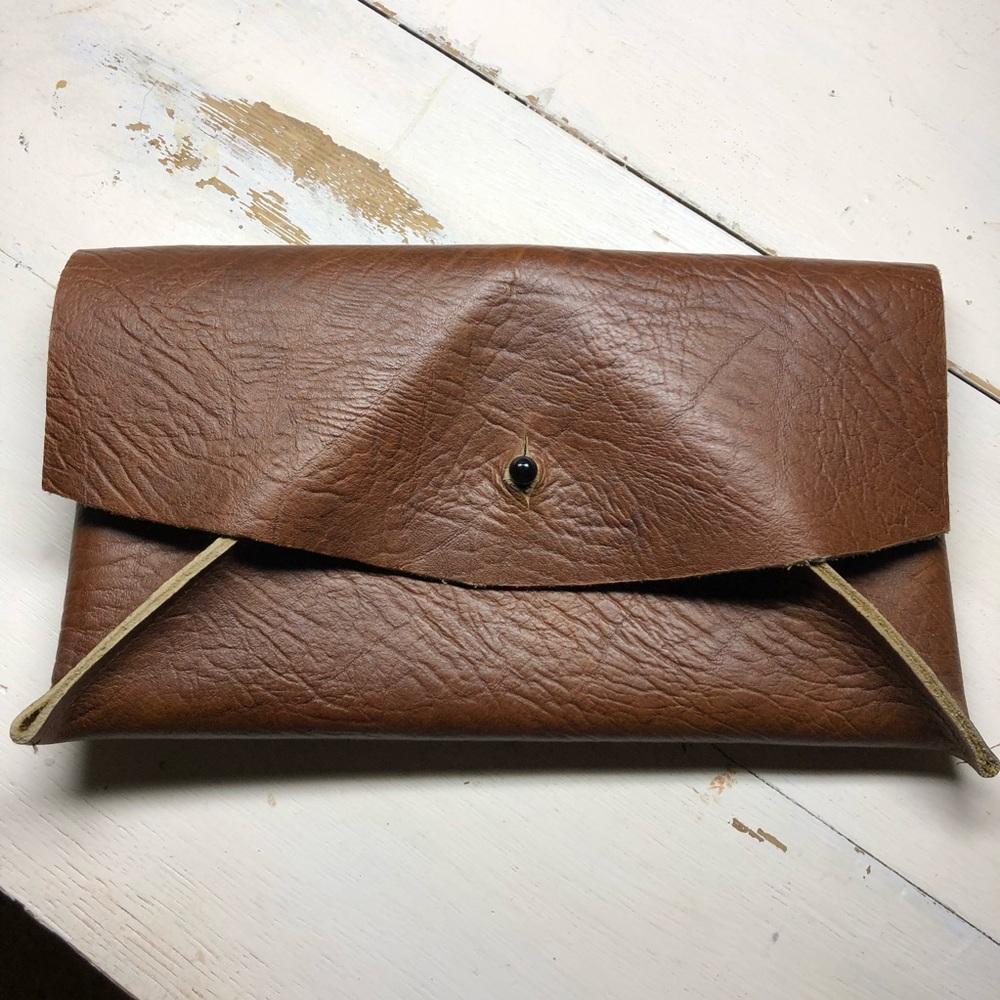 Handmade brown leather clutch.